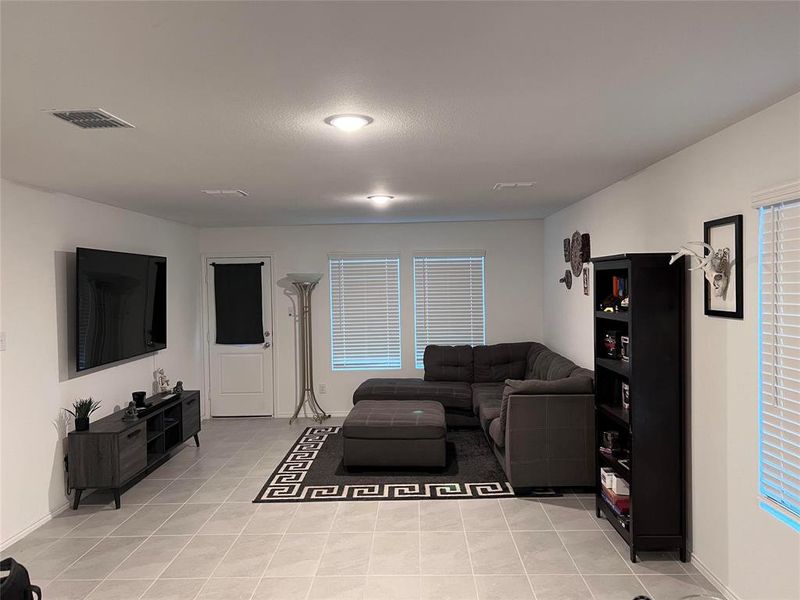 Living room with light tile patterned flooring Living room with light tile patterned flooring