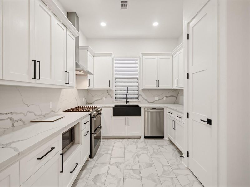 Kitchen: 8 ft. pantry door, 42" cabinets, soft closed drawers, quartz counter tops and back-splash, modern country kitchen sink, and stainless steel dish-washer,