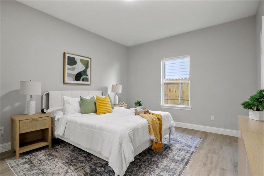 Bedroom with light hardwood / wood-style flooring