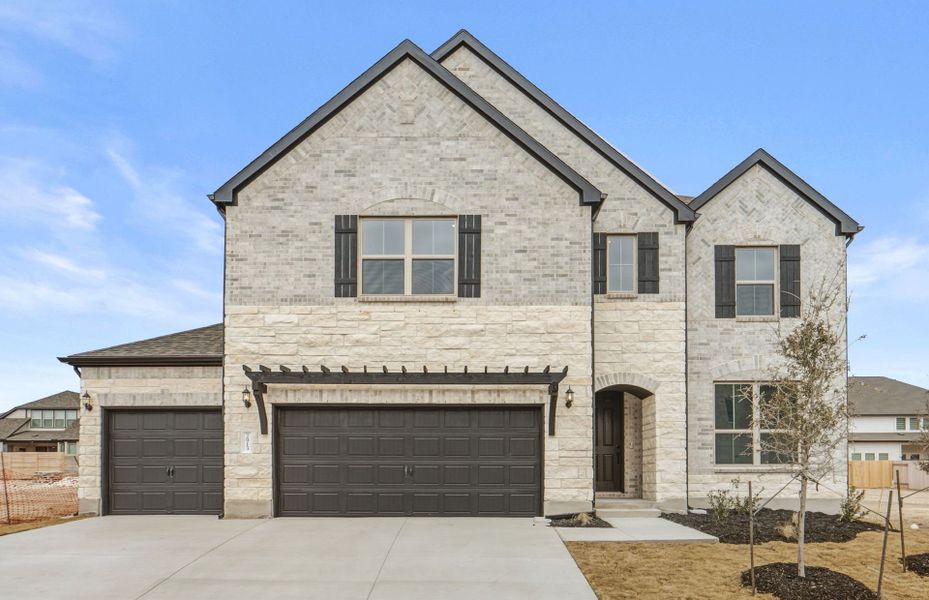 Front exterior of a new home in Bluffview Reserve, Leander, TX, highlighting curb appeal (Image 23).