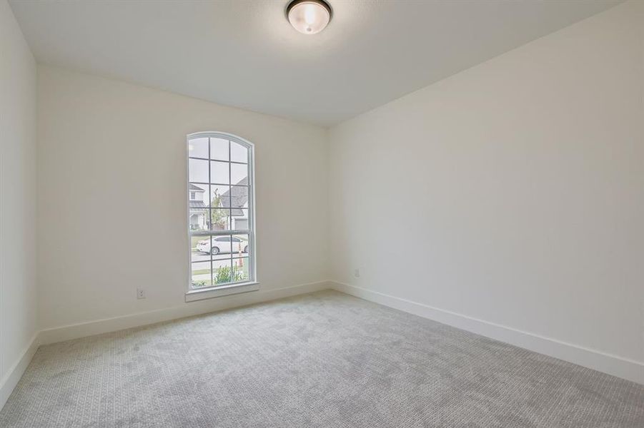 Empty room featuring carpet floors and baseboards