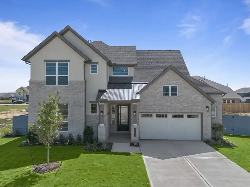 Front exterior of a new home in Fulshear Lakes, Fulshear, TX, highlighting curb appeal (Image 2). Front exterior of a new home in Fulshear Lakes, Fulshear, TX, highlighting curb appeal (Image 2).