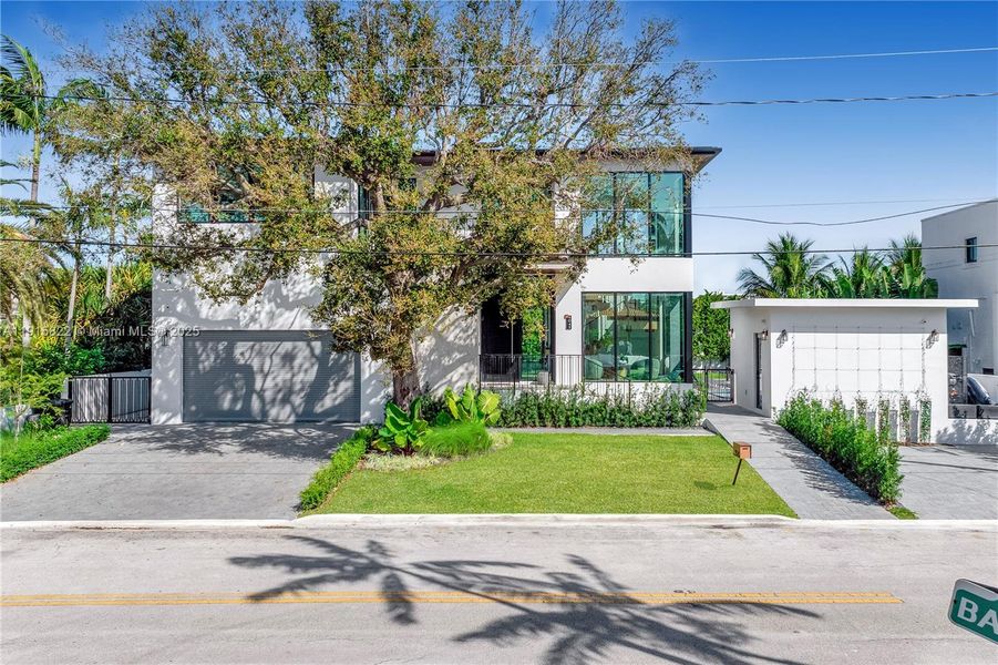 Front exterior of a new home in , Surfside, FL, highlighting curb appeal (Image 26). Front exterior of a new home in , Surfside, FL, highlighting curb appeal (Image 26).