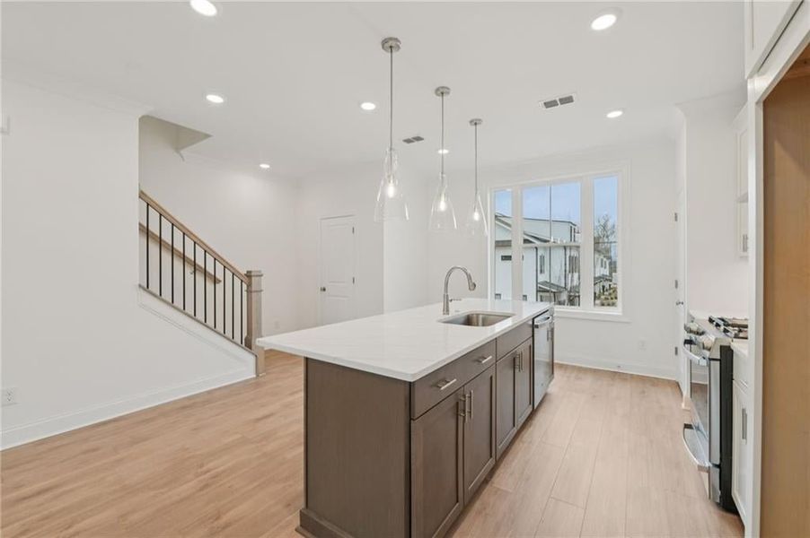 Quartz kitchen countertops, soft close doors and drawers in the kitchen, pendant lighting, lots of light