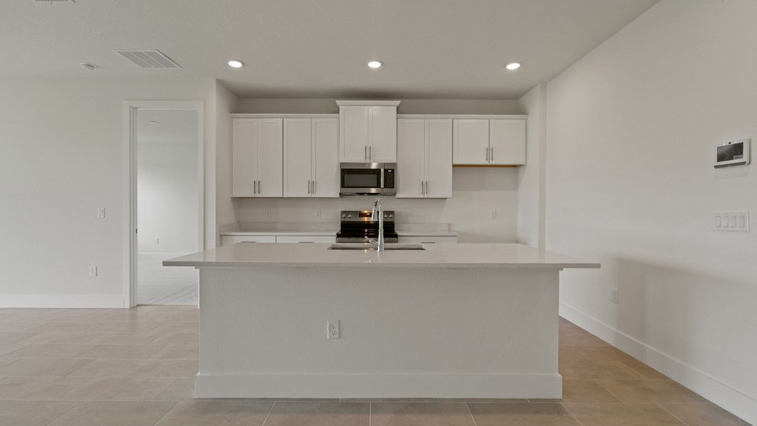 Kitchen in the Buttonwood floorplan by DRB Homes at Lakeside at Satilla in Saint Cloud, FL