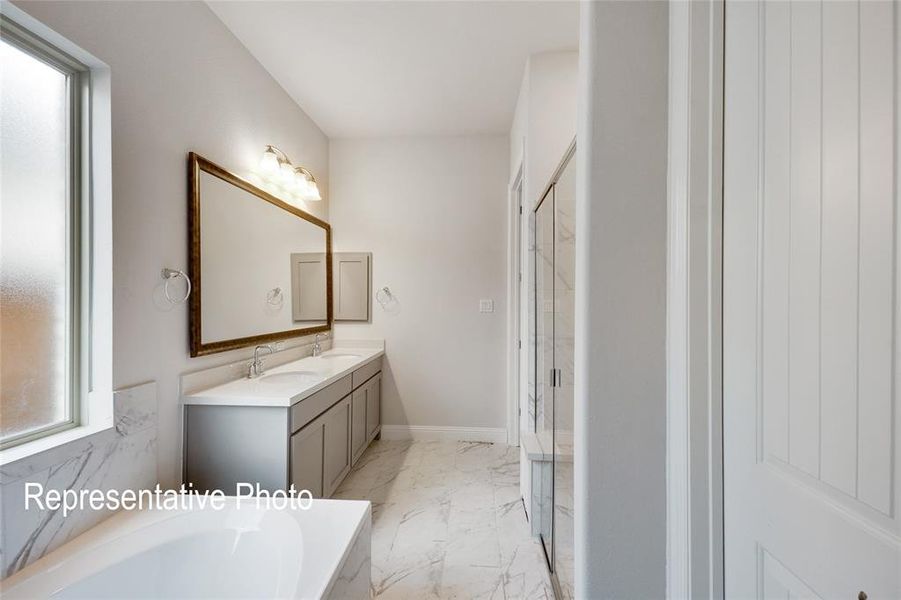 Bathroom featuring tile flooring, shower with separate bathtub, and dual bowl vanity