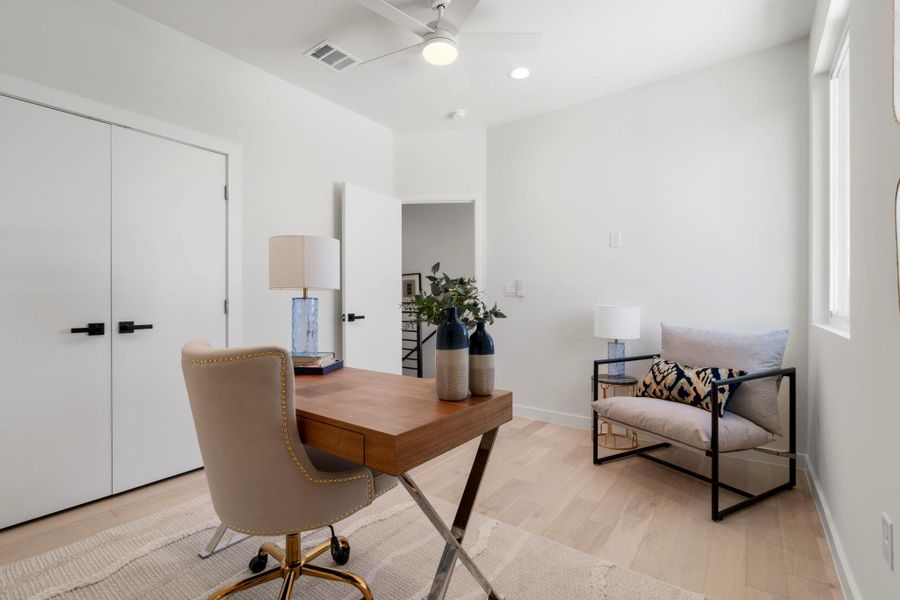 Office area featuring light wood-style flooring, a ceiling fan, and recessed lighting