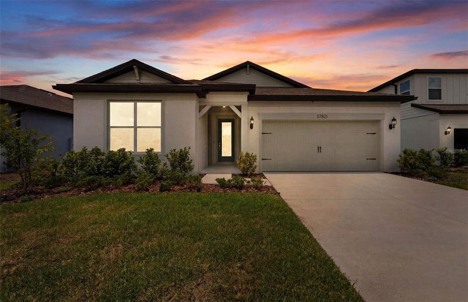 Front exterior of a new home in Riverwood, Zephyrhills, FL, highlighting curb appeal (Image 1). Front exterior of a new home in Riverwood, Zephyrhills, FL, highlighting curb appeal (Image 1).