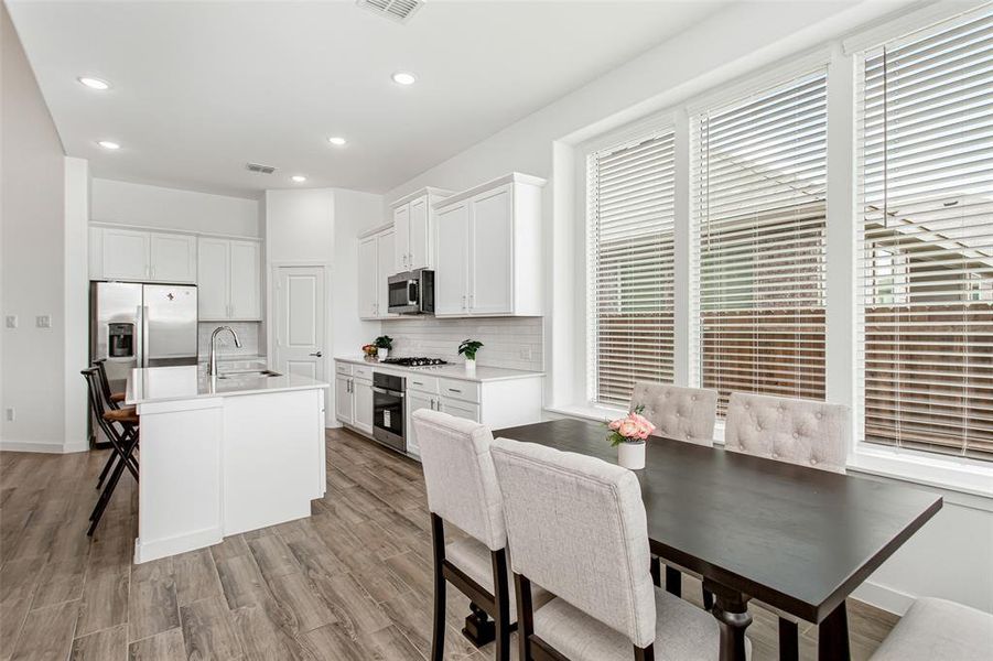 Large dining area overlooking backyard.