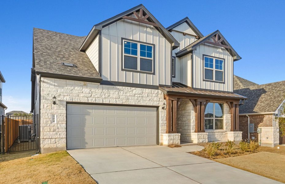 Front exterior of a new home in Saddleback at Santa Rita Ranch, Liberty Hill, TX, highlighting curb appeal (Image 20). Front exterior of a new home in Saddleback at Santa Rita Ranch, Liberty Hill, TX, highlighting curb appeal (Image 20).