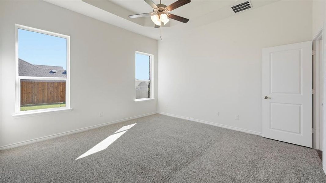 Spare room featuring carpet floors and ceiling fan Spare room featuring carpet floors and ceiling fan