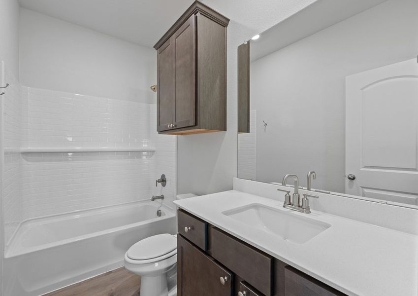 The secondary bathroom has a sprawling vanity and a shower-tub combo. The secondary bathroom has a sprawling vanity and a shower-tub combo.