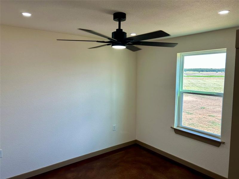 Unfurnished room featuring recessed lighting, concrete floors, and a ceiling fan