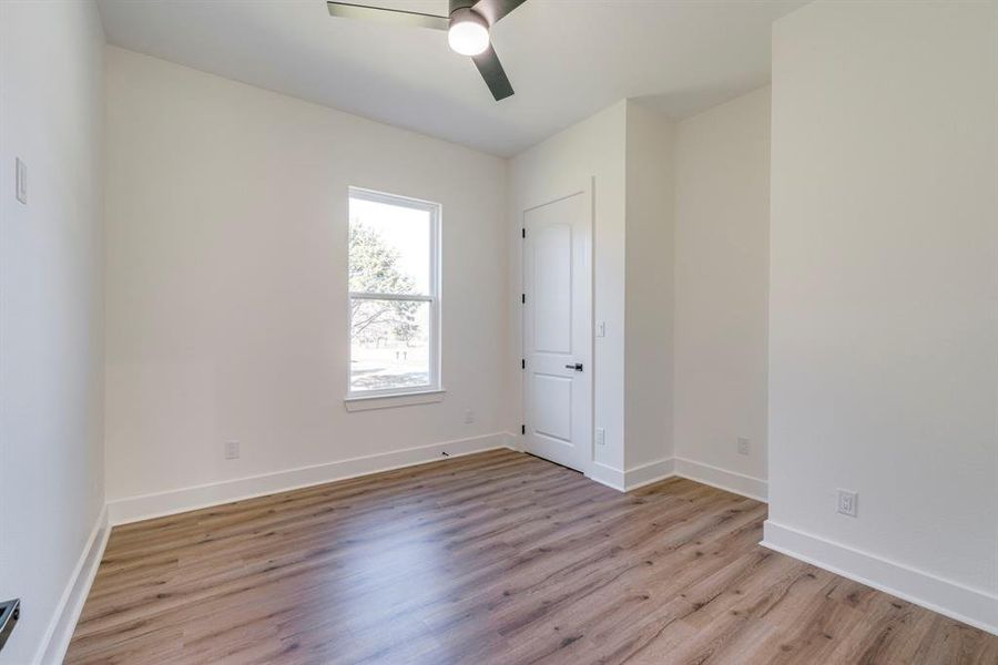 Unfurnished room with ceiling fan and light hardwood / wood-style flooring