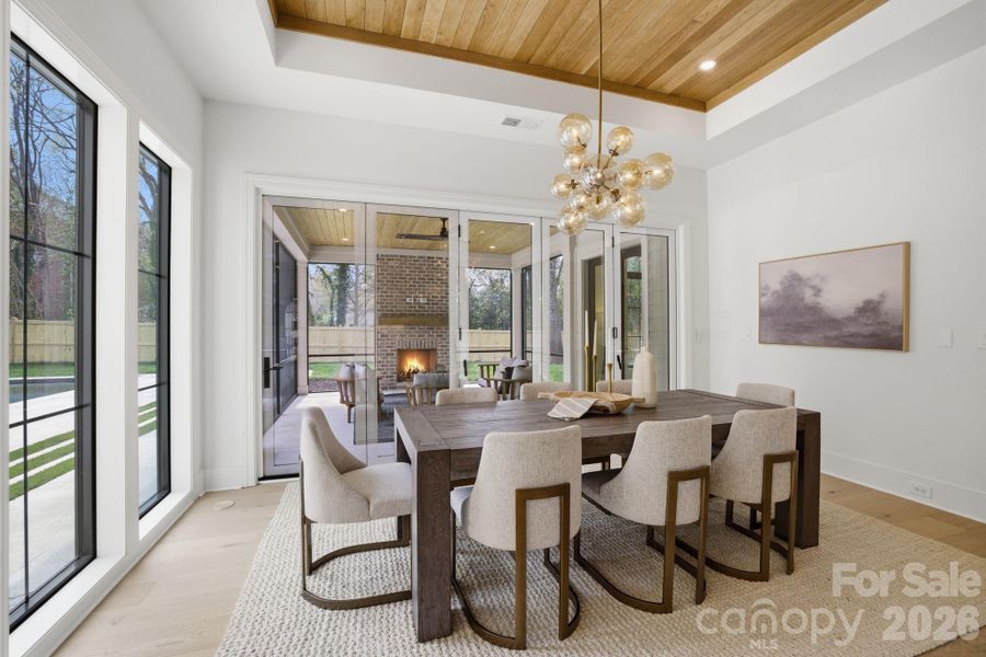 DINING AREA w/ ACCORDIAN DOOR OUT TO COVERED PATIO- Images represent a previously completed home by the builder showcasing a similar design and layout. Photos are intended to reflect overall design intent and craftsmanship; actual selections, materials, finishes, and features for this home may differ