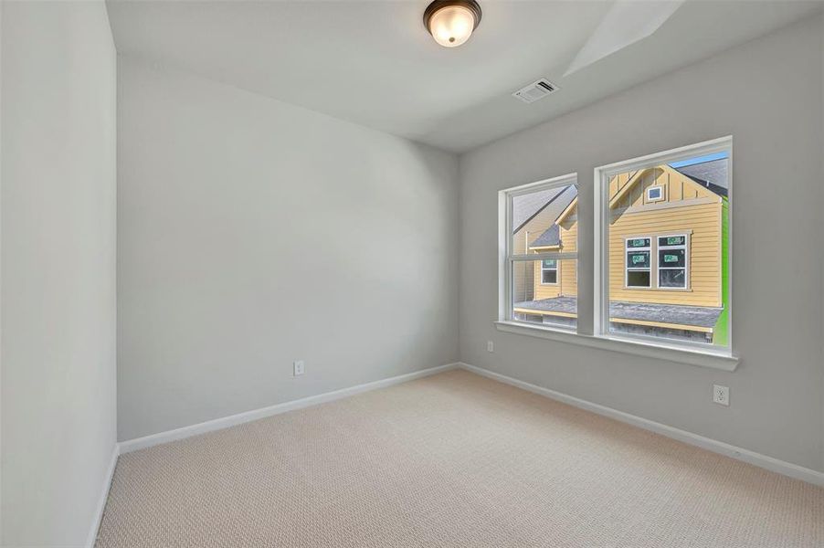 Empty room with light carpet and baseboards Empty room with light carpet and baseboards