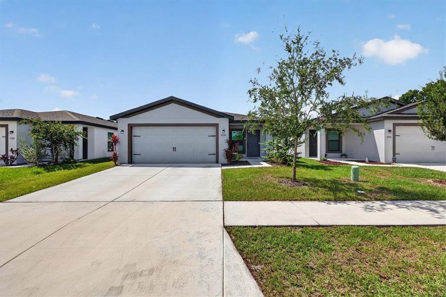 Front exterior of a new home in , Tampa, FL, highlighting curb appeal (Image 25).