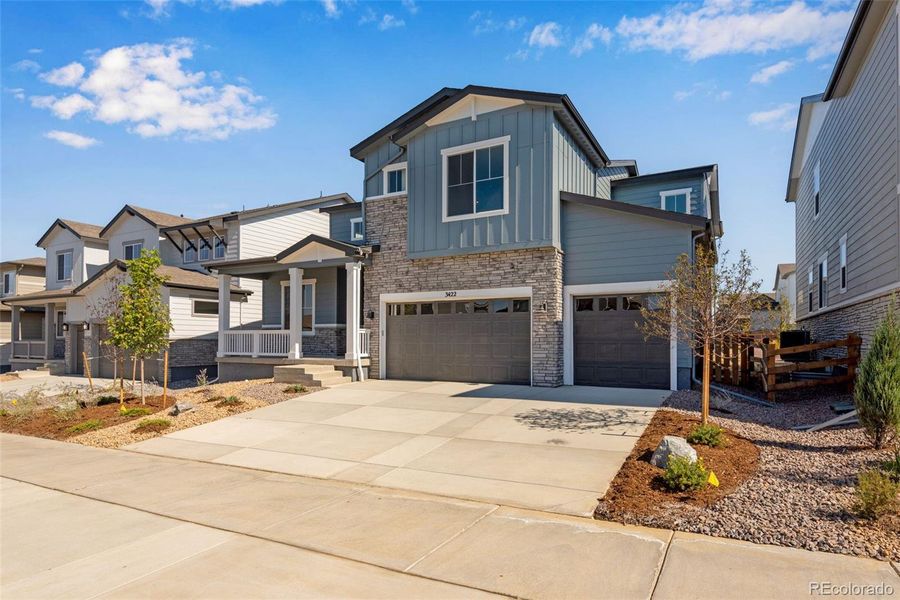 Front exterior of a new home in Ensemble at The Aurora Highlands, Aurora, CO, highlighting curb appeal (Image 26). Front exterior of a new home in Ensemble at The Aurora Highlands, Aurora, CO, highlighting curb appeal (Image 26).