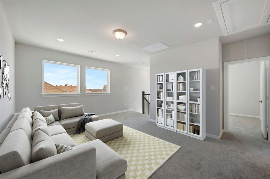 Living area featuring light carpet and recessed lighting