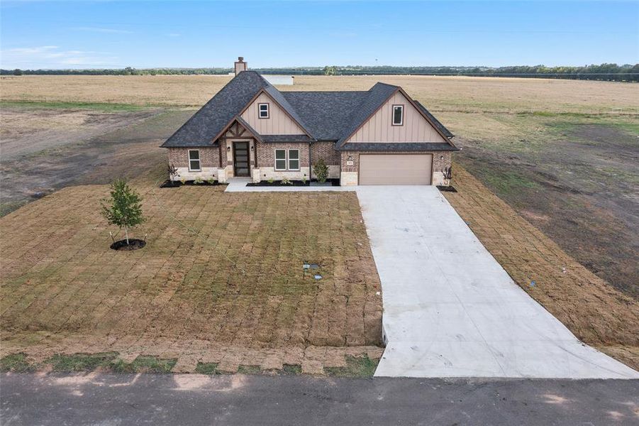 View of front of house featuring a garage and a rural view