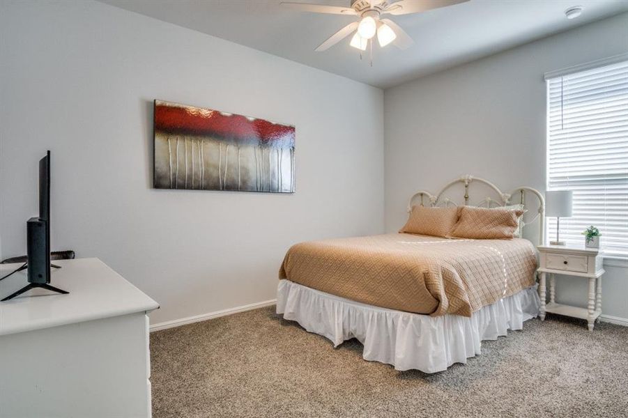 Bedroom with baseboards and light carpet