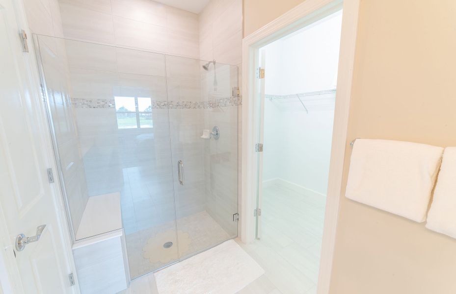 Owner's bath with stylish shower and walk-in closet