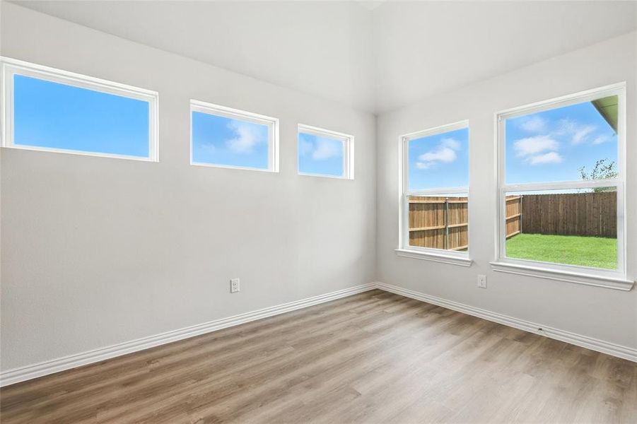 Unfurnished room featuring light wood finished floors and baseboards