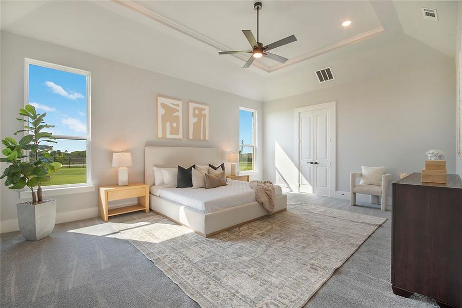 Bedroom with a tray ceiling, carpet floors, ceiling fan, a closet, and recessed lighting Bedroom with a tray ceiling, carpet floors, ceiling fan, a closet, and recessed lighting