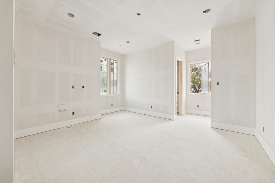 Bright and spacious secondary bedroom featuring high ceilings and a front-facing view through large windows that flood the room with natural light. This versatile suite includes a private en-suite bathroom and is designed with clean modern lines and premium finishes. The expansive layout and contemporary aesthetic make this an ideal guest suite or secondary retreat, offering both comfort and privacy. Bright and spacious secondary bedroom featuring high ceilings and a front-facing view through large windows that flood the room with natural light. This versatile suite includes a private en-suite bathroom and is designed with clean modern lines and premium finishes. The expansive layout and contemporary aesthetic make this an ideal guest suite or secondary retreat, offering both comfort and privacy.