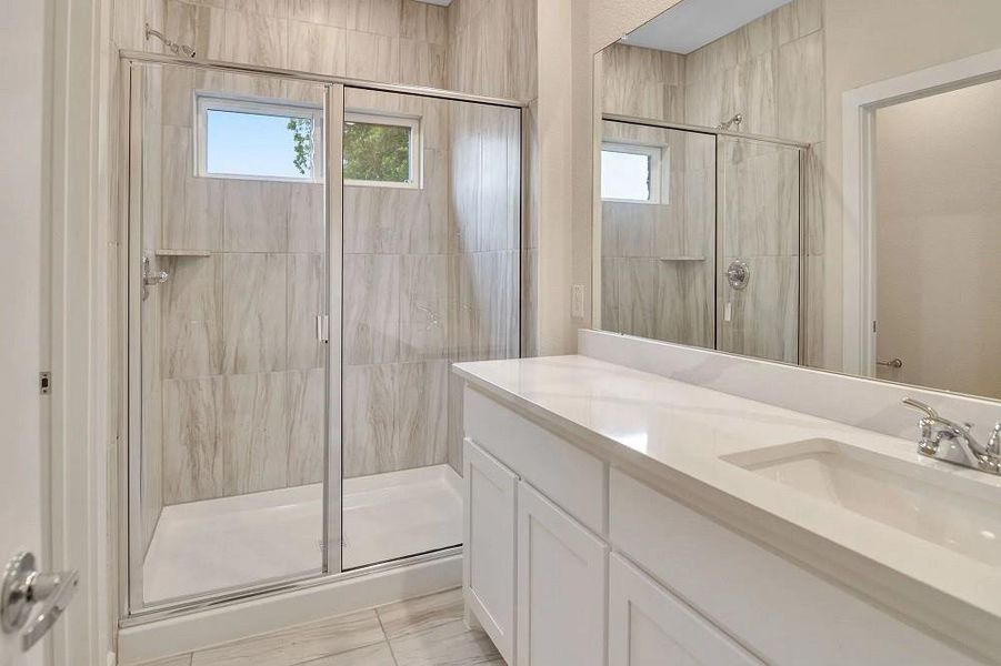 Full bathroom featuring a shower stall and vanity Full bathroom featuring a shower stall and vanity