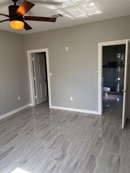 Spare room with ceiling fan and wood tiled floors Spare room with ceiling fan and wood tiled floors