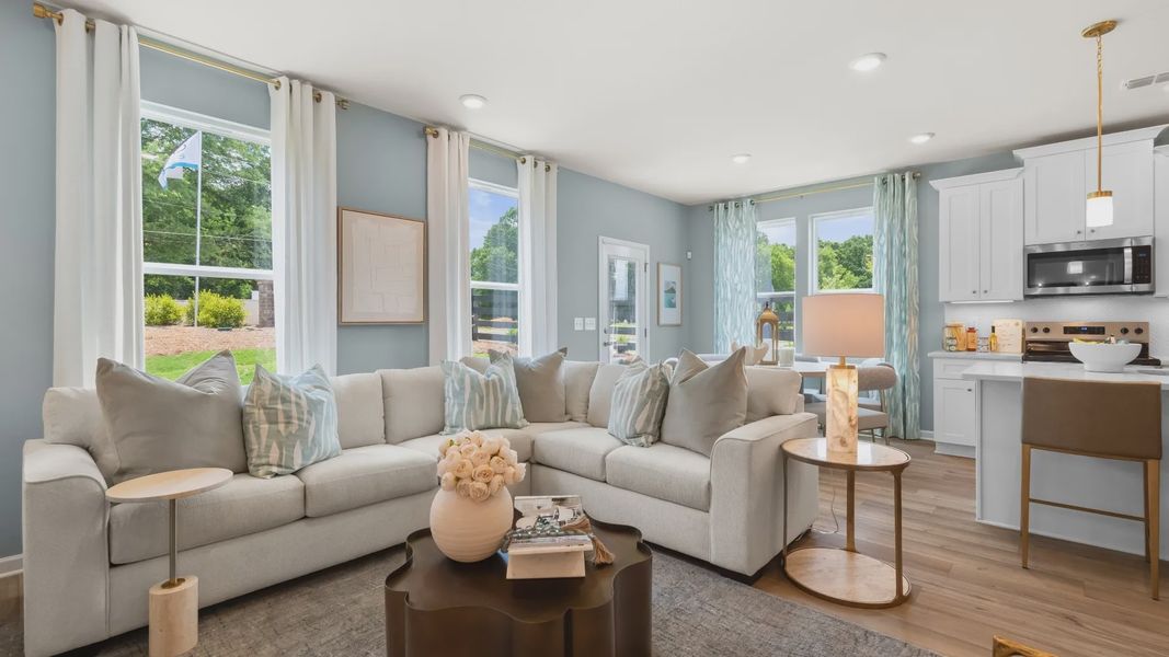 Open concept kitchen and family room in new construction townhome with seamless flow and natural light.