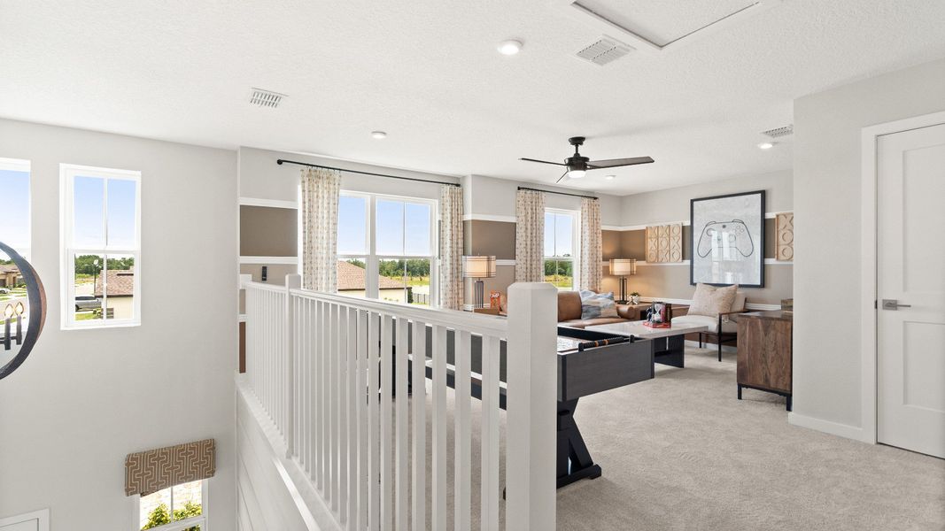 Second Floor Loft Space staged as a game room in this New Construction Home in Winter Haven by DRB Homes in Willowbrook North