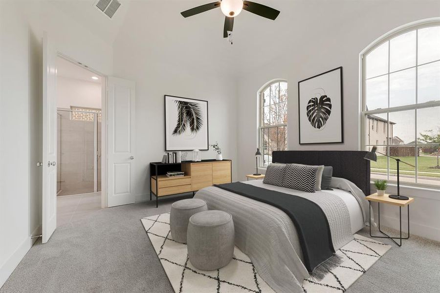 Bedroom with light colored carpet, a ceiling fan, ensuite bath, and vaulted ceiling Bedroom with light colored carpet, a ceiling fan, ensuite bath, and vaulted ceiling