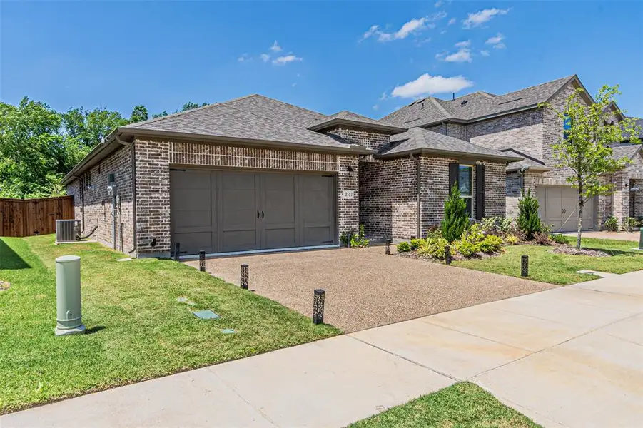 Front exterior of a new home in Stoneridge, Melissa, TX, highlighting curb appeal (Image 22). Front exterior of a new home in Stoneridge, Melissa, TX, highlighting curb appeal (Image 22).