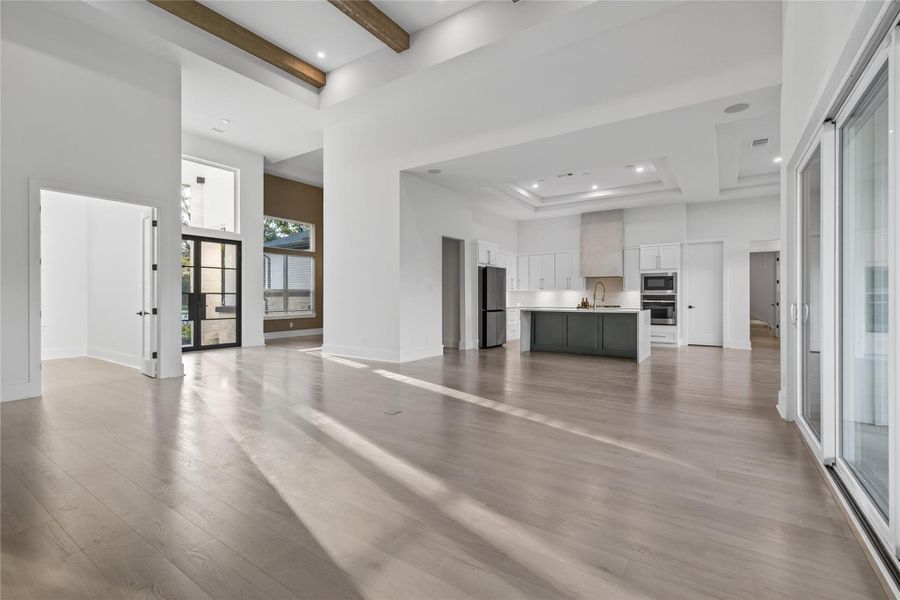 The living area offers a bright, versatile space with warm flooring, recessed lighting, and plenty of room for relaxing or entertaining. **Images are from a previously completed project. **