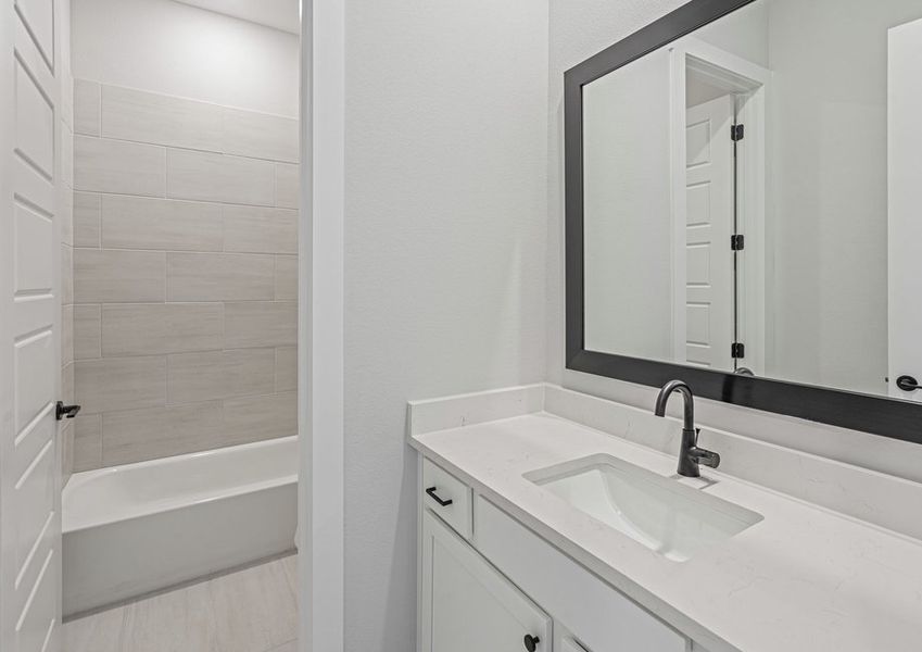 The secondary bathroom has a sprawling vanity space.