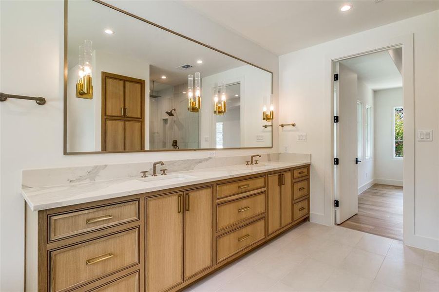 Bathroom featuring a shower stall, double vanity, recessed lighting, and light tile patterned floors Bathroom featuring a shower stall, double vanity, recessed lighting, and light tile patterned floors