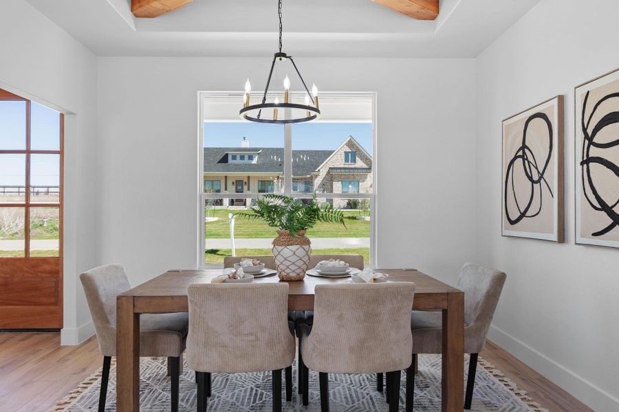 Dining room with light wood finished floors and a chandelier Dining room with light wood finished floors and a chandelier