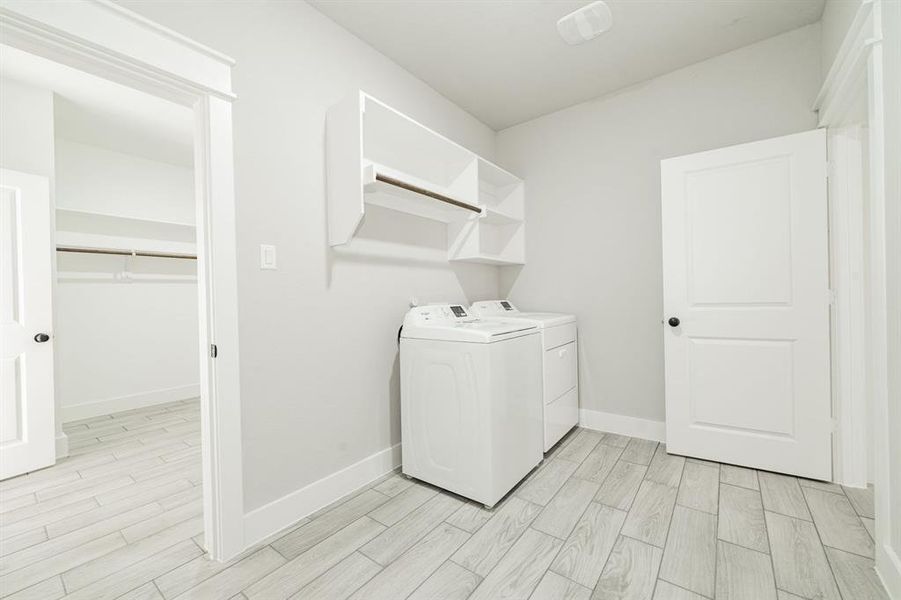 Laundry room with wood-tiled floors and brand new Whirlpool washer and dryer set (included) Laundry room with wood-tiled floors and brand new Whirlpool washer and dryer set (included)