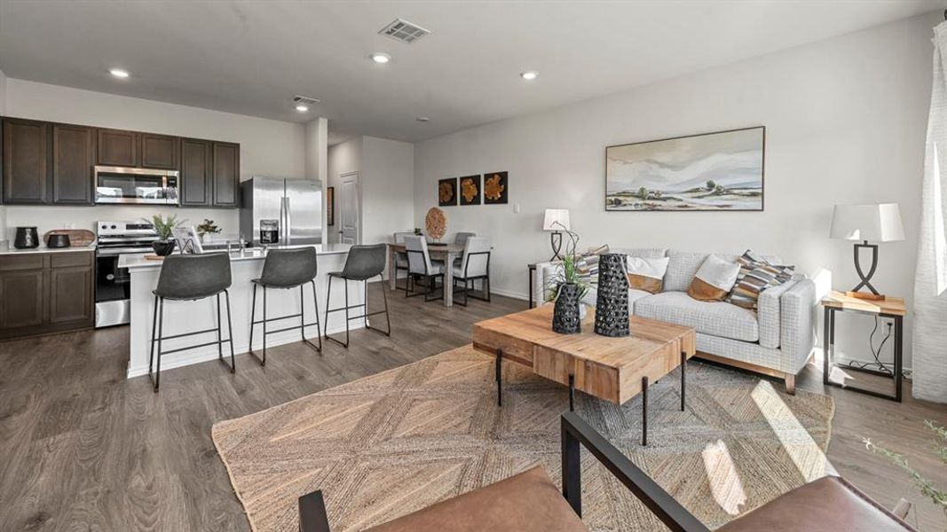 Living room with recessed lighting and dark wood-style floors