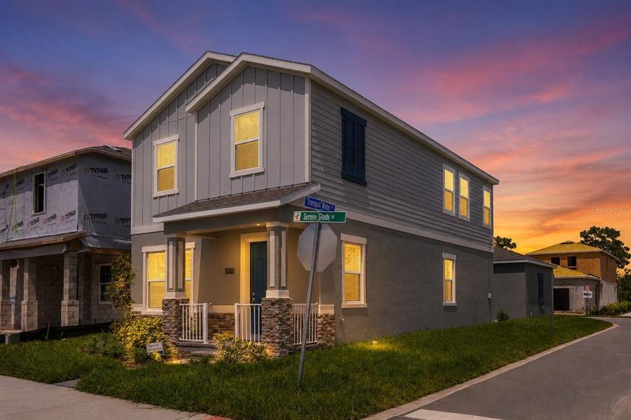 Front exterior of a new home in Serenade at Ovation, Winter Garden, FL, highlighting curb appeal (Image 2). Front exterior of a new home in Serenade at Ovation, Winter Garden, FL, highlighting curb appeal (Image 2).