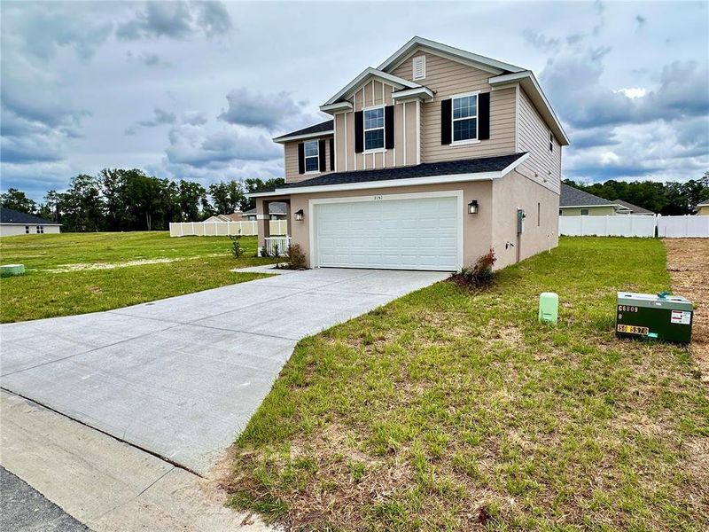 Front exterior of a new home in , Ocala, FL, highlighting curb appeal (Image 1). Front exterior of a new home in , Ocala, FL, highlighting curb appeal (Image 1).