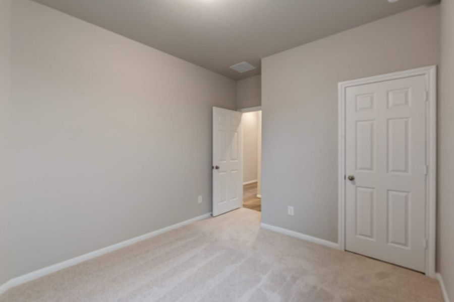 An additional view of the third bedroom and closet.