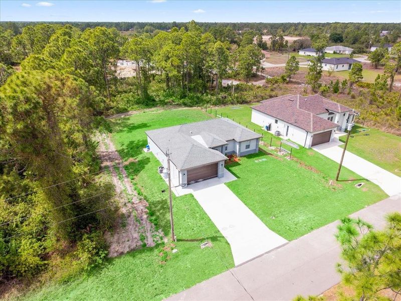Front exterior of a new home in , Lehigh Acres, FL, highlighting curb appeal (Image 20).
