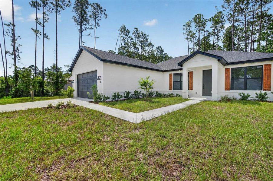 Front exterior of a new home in , Palm Coast, FL, highlighting curb appeal (Image 22). Front exterior of a new home in , Palm Coast, FL, highlighting curb appeal (Image 22).