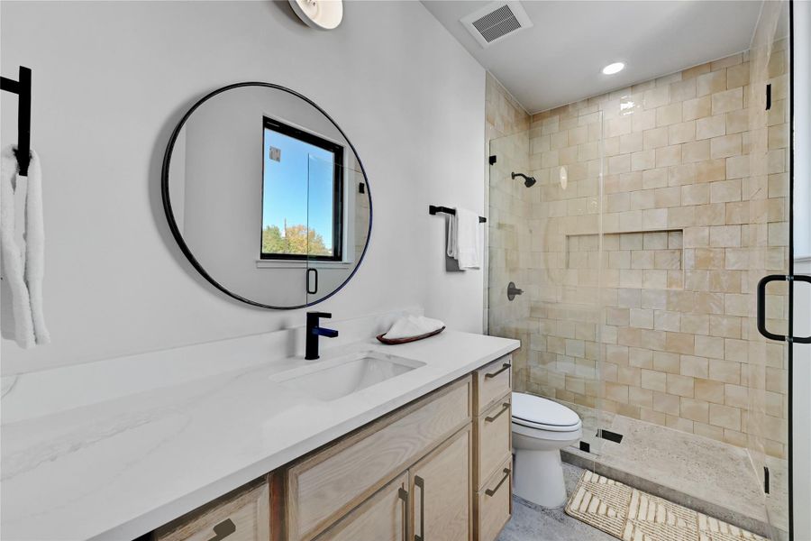 Full bath with vanity, a shower stall, and recessed lighting