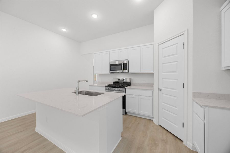 Kitchen in the Cypress home plan by Trophy Signature Homes - REPRESENTATIVE PHOTO