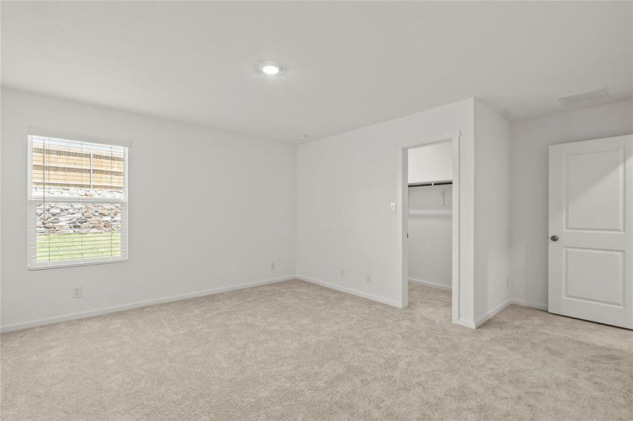 Room with light-colored carpeting, white walls, and a recessed ceiling light