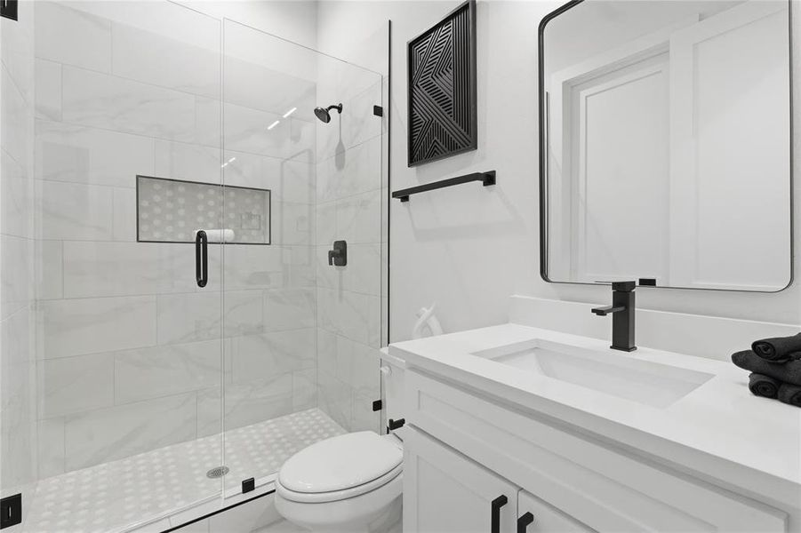 Bathroom featuring vanity and a shower stall